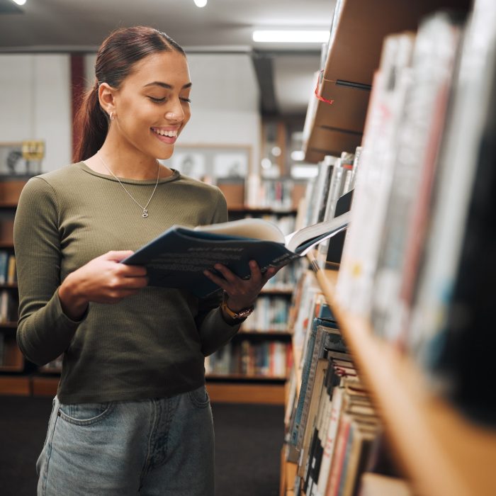 Reading, library book and woman student with a smile about learning, books and college study. Unive